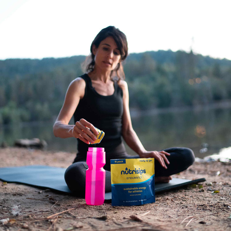 Woman in serence nature setting with Nutrisips Endurance